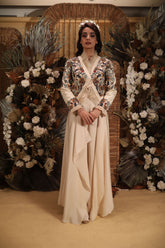 beige jacket with ruffles and draped pants